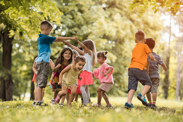 Group of happy little children having fun in the park