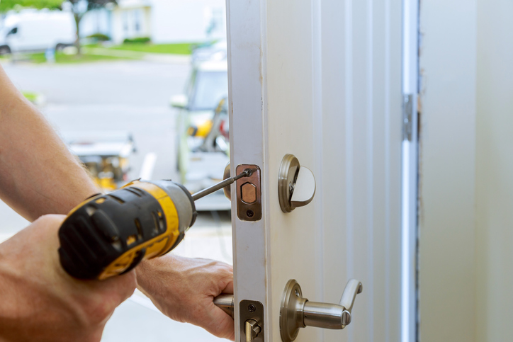 man repairing the doorknob