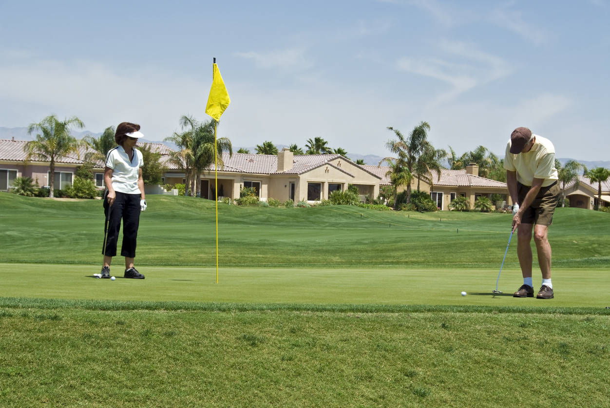 Husband and wife playing golf